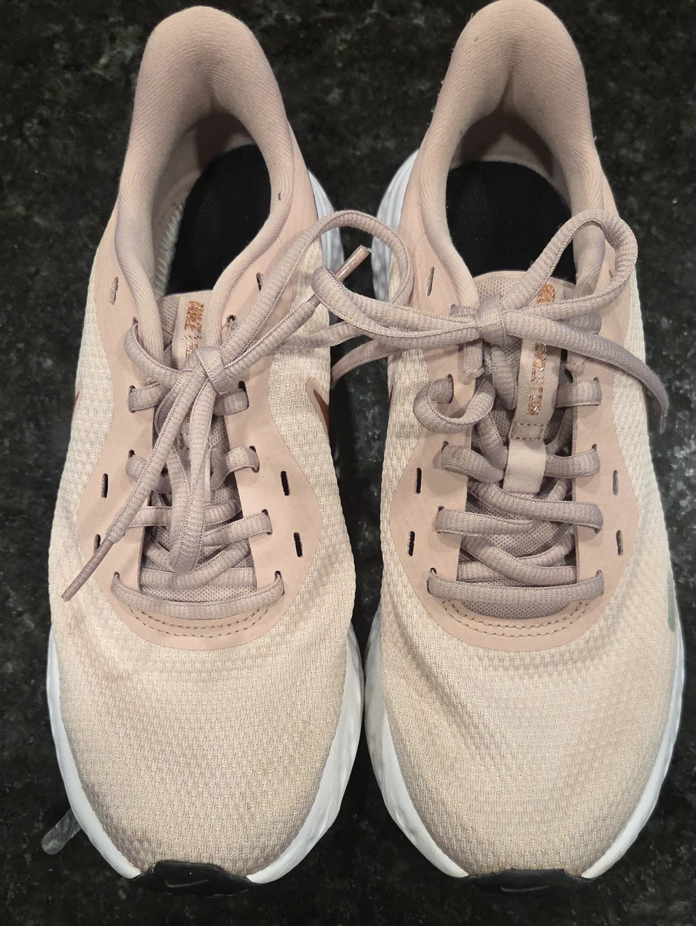 Nike Revolution Women’s Blush Pink Athletic Running Shoes with Rose-Gold Swoosh.